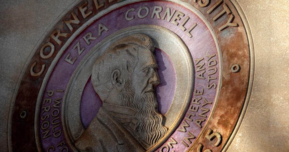 Cornell seal outside Day Hall is lit by the morning sun